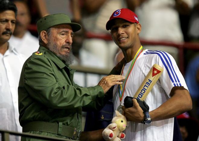 File picture of then-Cuban President Castro handing out a baseball bat to Cuban player Gourriel in Havana
